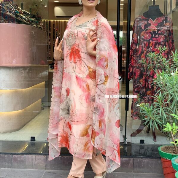 Woman wearing a premium organza embroidered floral print straight kurta with matching pants and dupatta – elegant 3-piece partywear salwar kameez set for women