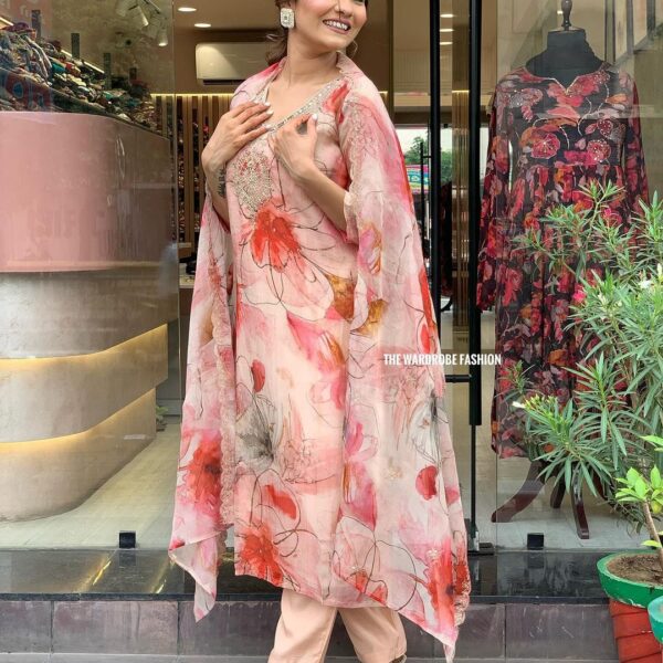 Woman wearing a premium organza embroidered floral print straight kurta with matching pants and dupatta – elegant 3-piece partywear salwar kameez set for women